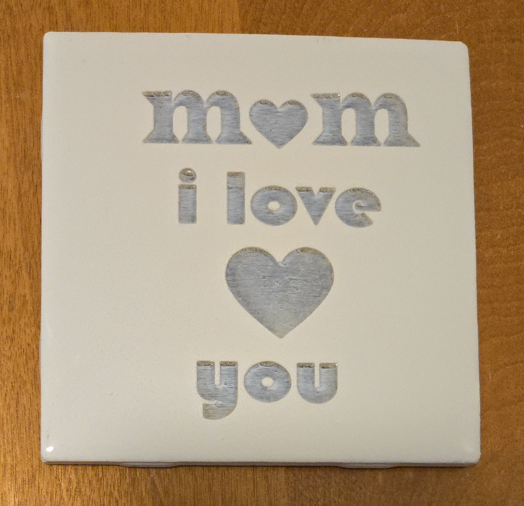 Laser-engraved 'Mom I Love You' ceramic tile with heart design, perfect Mother's Day gift by PetiteTrace