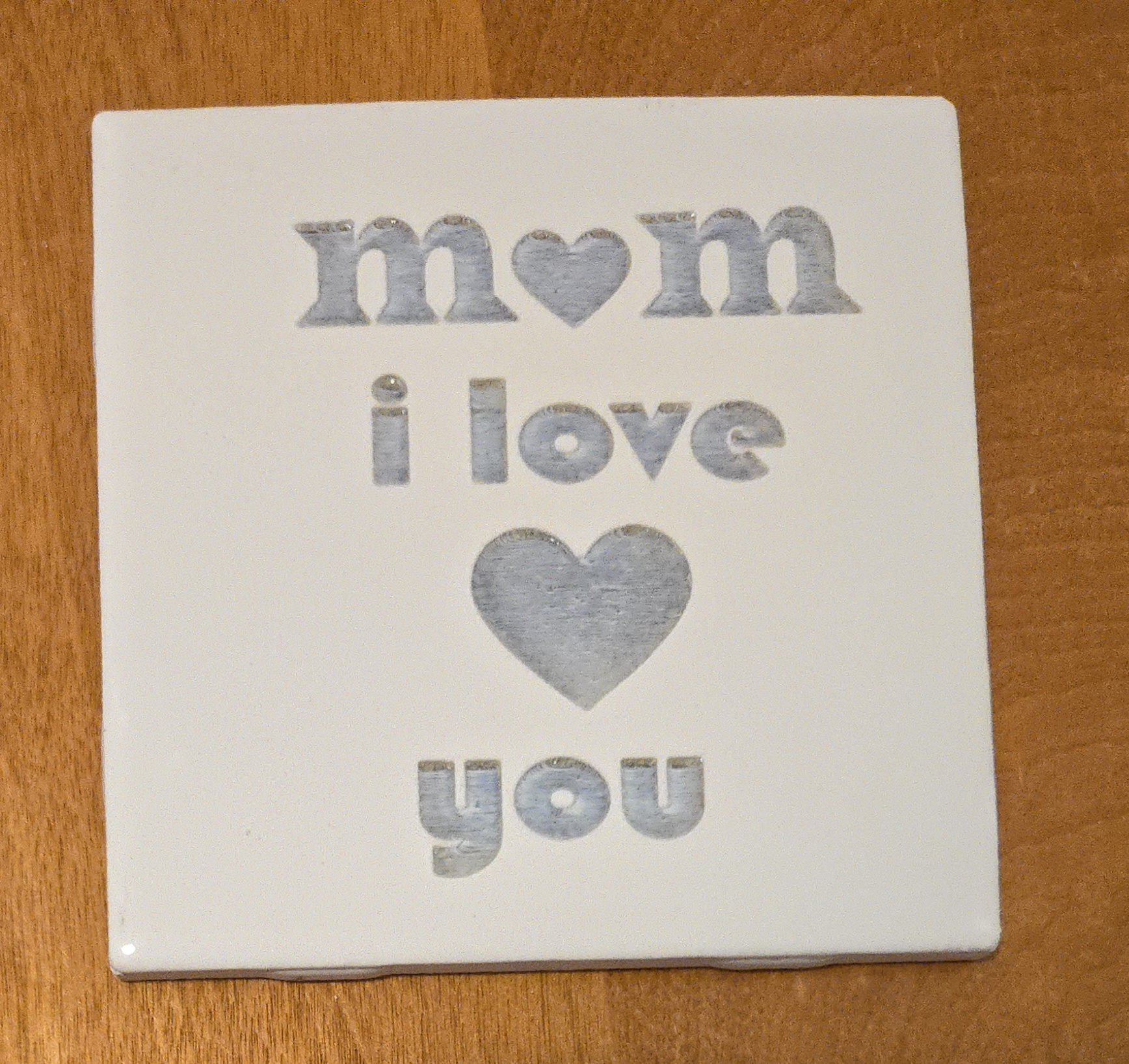 Laser-engraved 'Mom I Love You' ceramic tile with heart design, perfect Mother's Day gift by PetiteTrace