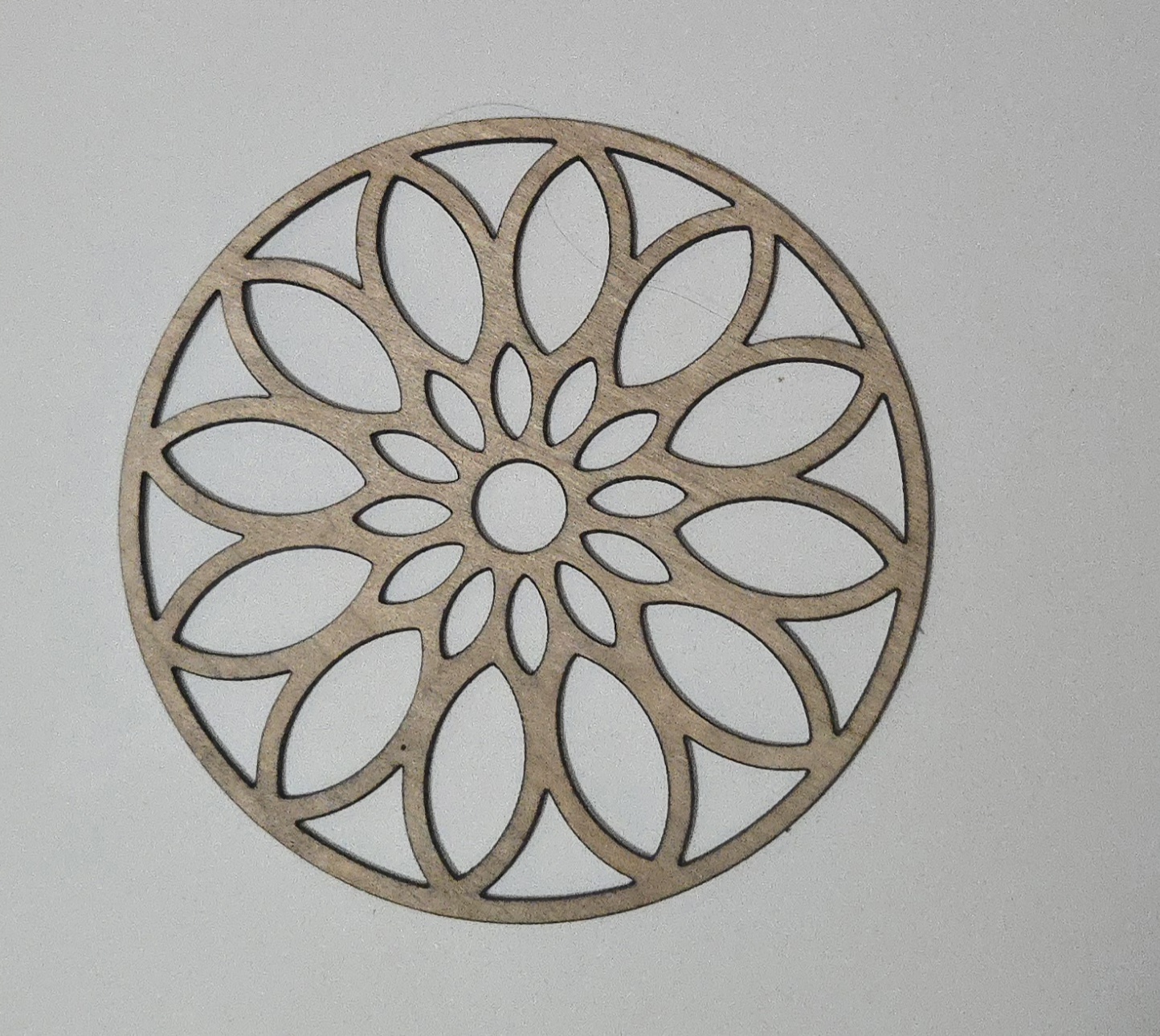 Intricate laser-cut wooden mandala design, coaster or ornament by PetiteTrace