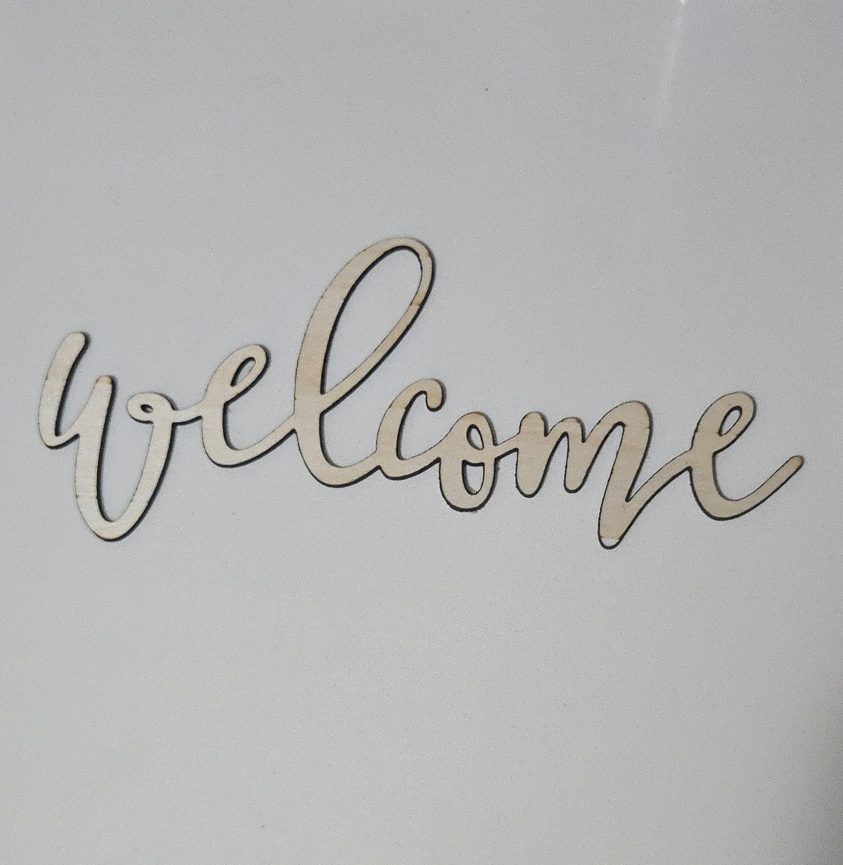Laser-cut wooden 'welcome' script sign for home decor by PetiteTrace